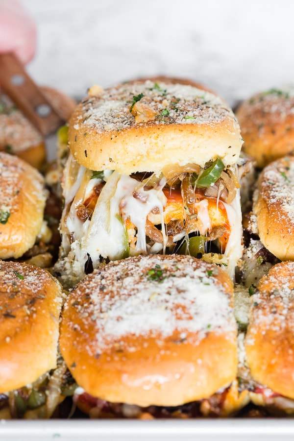 These baked supreme pizza sliders are the new baked sandwiches of your dreams. They taste just like loaded supreme pizza made with marinara sauce, spicy Italian sausage, pepperoni, mushrooms, green peppers, onions and lots of mozzarella cheese. You