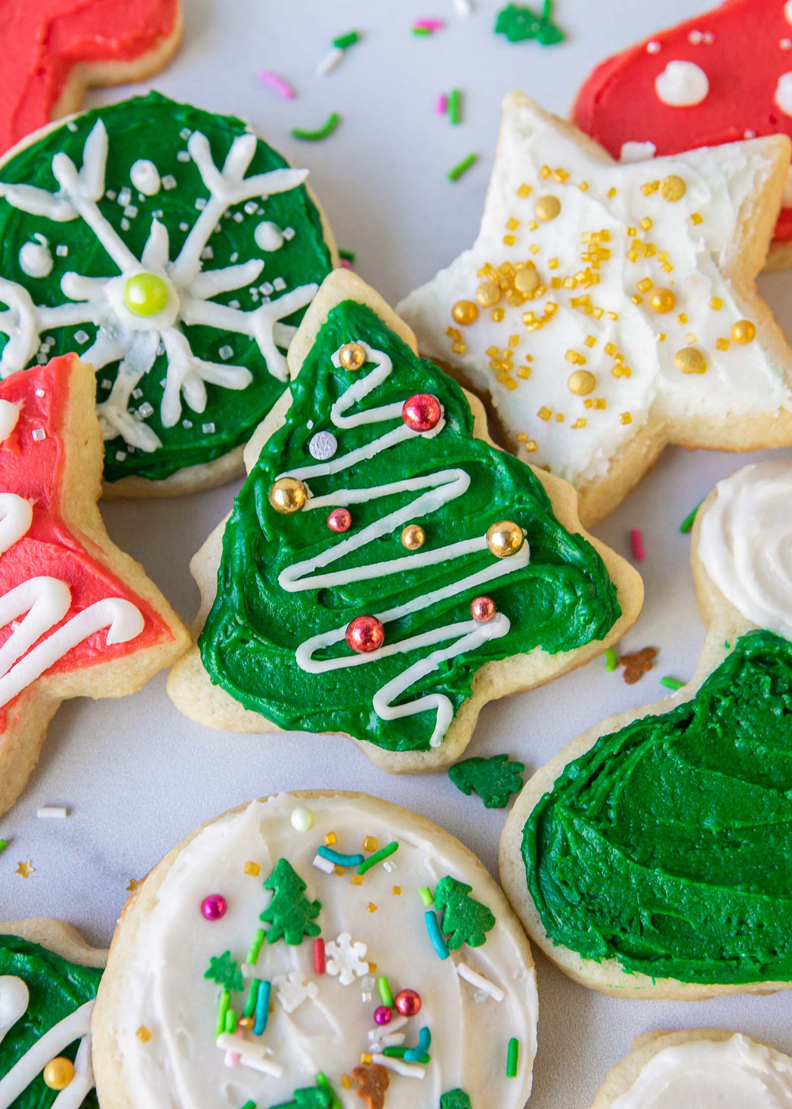 Christmas sugar cookies frosted and topped with sprinkles.