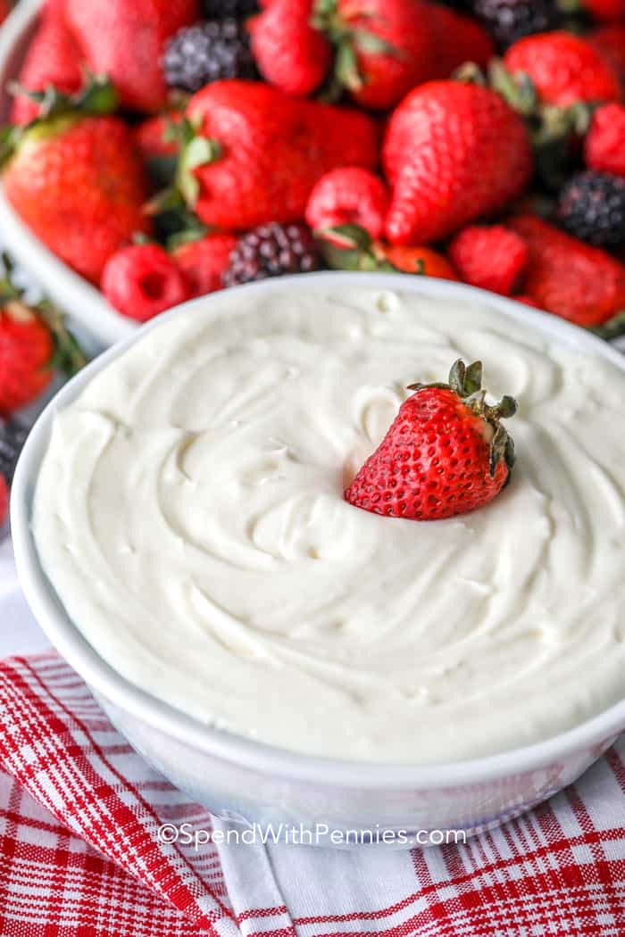 Fruit dip in a white bowl with a strawberry on top
