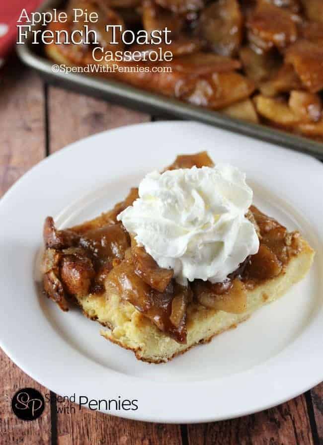 Apple Pie French Toast Casserole with whipping cream on a white plate with the casserole in the background