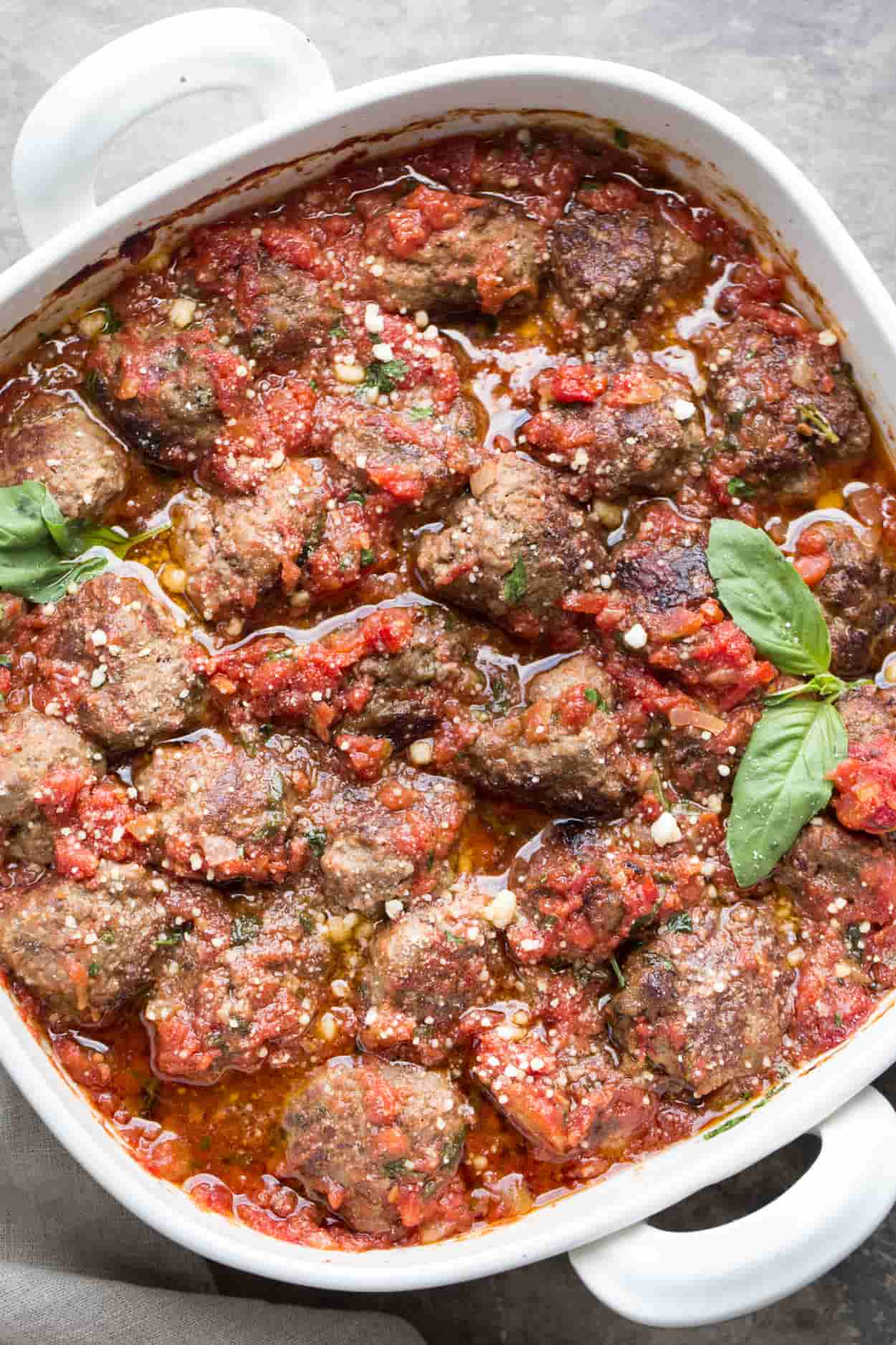 Meatball recipe made from scratch and baked to perfection in a homemade marinara sauce. Baked in a casserole dish.