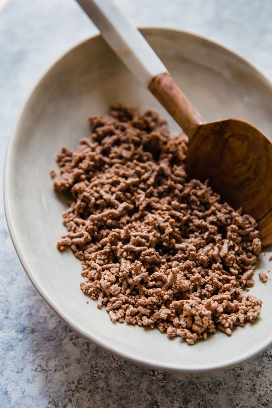 Wondering how to cook ground beef? Frying is a popular option, but boiling ground beef is easy, quick, and it creates leaner meat! Cooking ground beef with this method creates the perfect crumbled ground beef for tacos, chili, spaghetti sauce, and more.