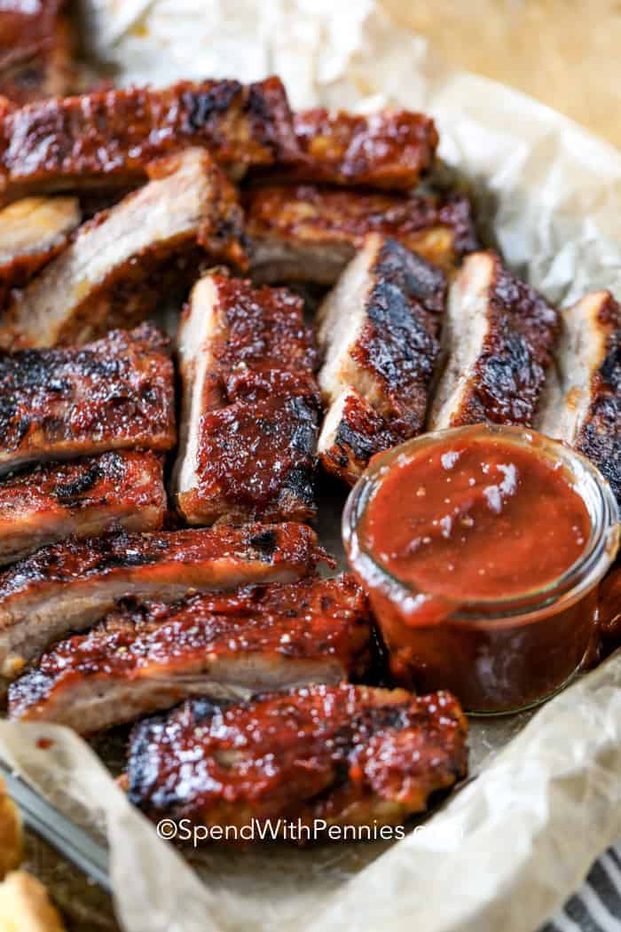 Crock Pot Ribs on a baking sheet with dipping sauce