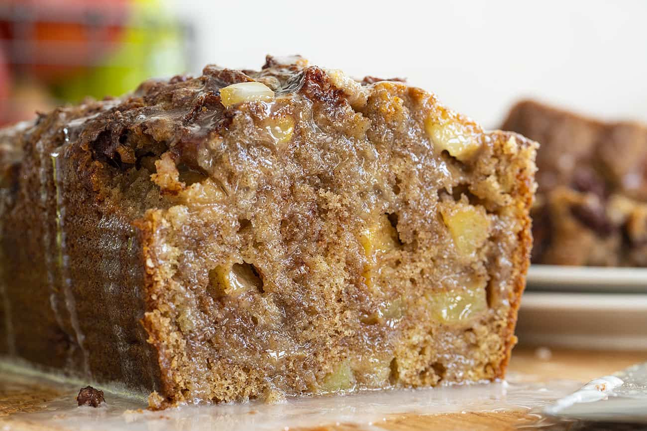 Apple Fritter Bread with Chunks of Apples Showing and Glaze Seeping over Bread