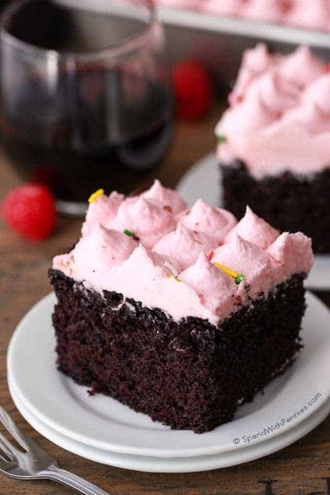 Red Wine Cake with pink frosting on a white plate