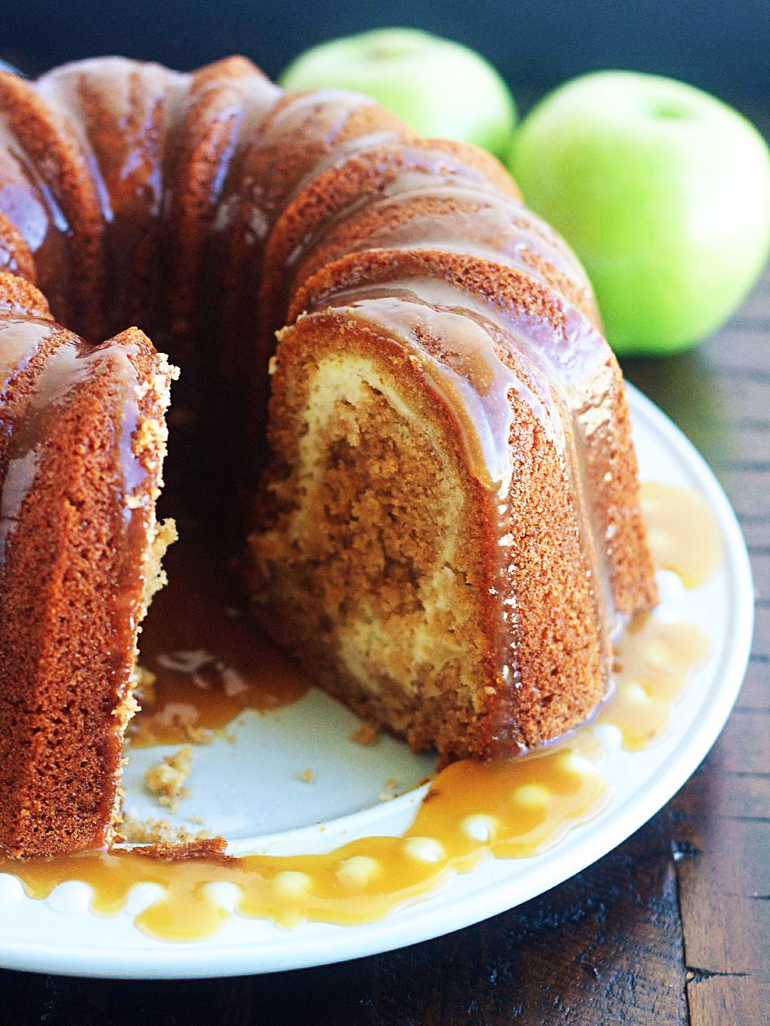 Apple Bundt cake with Cream Cheese Swirl is a moist, delicious apple bundt cake filled with cream cheese and topped with a caramel sauce. Life-in-the-Lofthouse.com